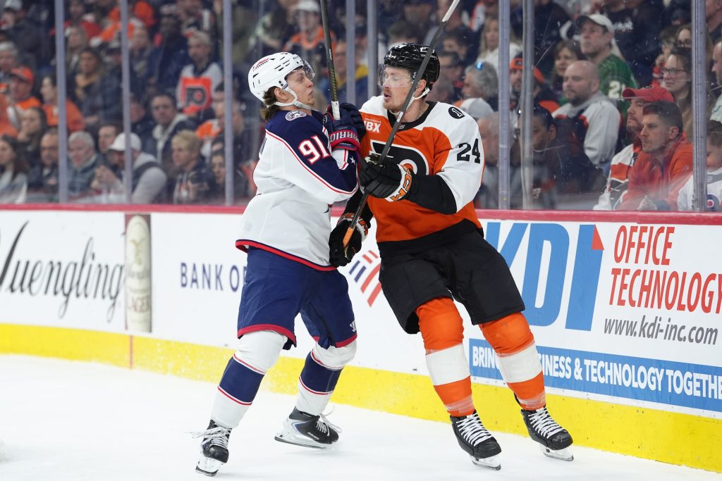 Mar 24, 2026; Philadelphia, Pennsylvania, USA; Columbus Blue Jackets center Kent Johnson (91) hits Philadelphia Flyers defenseman Nick Seeler (24) in the second period at Xfinity Mobile Arena.