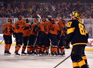 Feb 23, 2019; Philadelphia, PA, USA; The Philadelphia Flyers celebrate the game-winning goal by center Claude Giroux (not pictured) as Pittsburgh Penguins center Sidney Crosby&nbsp;(87) skates by in a Stadium Series ice hockey game at Lincoln Financial Field.
