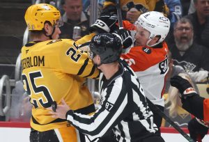 Apr 18, 2026; Pittsburgh, Pennsylvania, USA; Pittsburgh Penguins left wing Elmer Soderblom (25) and Philadelphia Flyers defenseman Travis Sanheim (6) tussle as linesman linesman Devin Berg (87) separates the two during the first period against in game one of the first round of the 2026 Stanley Cup Playoffs at PPG Paints Arena.