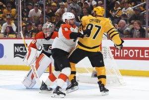 Apr 18, 2026; Pittsburgh, Pennsylvania, USA; Philadelphia Flyers defenseman Cam York (8) checks Pittsburgh Penguins center Sidney Crosby (87) in front of Flyers goaltender Dan Vladar (80) during the first period against in game one of the first round of the 2026 Stanley Cup Playoffs at PPG Paints Arena.