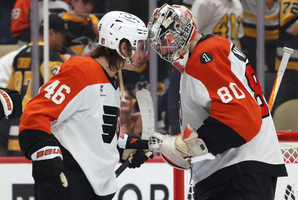 Apr 18, 2026; Pittsburgh, Pennsylvania, USA; Philadelphia Flyers center Trevor Zegras (46) and goaltender Dan Vladar (80) celebrate after defeating the Pittsburgh Penguins in game one of the first round of the 2026 Stanley Cup Playoffs at PPG Paints Arena.