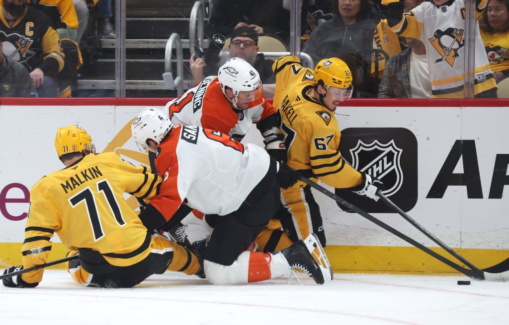 Apr 20, 2026; Pittsburgh, Pennsylvania, USA; Pittsburgh Penguins center Evgeni Malkin (71) and right wing Rickard Rakell (67) battle for the puck against Philadelphia Flyers defenseman Travis Sanheim (6) and center Luke Glendening (41) in game two of the first round of the 2026 Stanley Cup Playoffs at PPG Paints Arena.