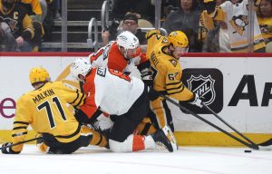 Apr 20, 2026; Pittsburgh, Pennsylvania, USA; Pittsburgh Penguins center Evgeni Malkin (71) and right wing Rickard Rakell (67) battle for the puck against Philadelphia Flyers defenseman Travis Sanheim (6) and center Luke Glendening (41) in game two of the first round of the 2026 Stanley Cup Playoffs at PPG Paints Arena.