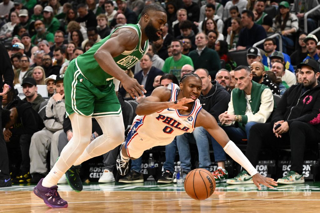 Apr 21, 2026; Boston, Massachusetts, USA; Boston Celtics guard Jaylen Brown (7) and Philadelphia 76ers guard Tyrese Maxey (0) dive for the ball in the first half of a game two of the first round of the 2026 NBA Playoffs at TD Garden.
