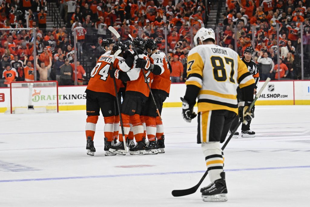 Apr 22, 2026; Philadelphia, Pennsylvania, USA; Philadelphia Flyers right wing Owen Tippett (74) celebrates his empty goal with teammates against Pittsburgh Penguins center Sidney Crosby (87) during the third period in game three of the first round of the 2026 Stanley Cup Playoffs at Xfinity Mobile Arena.