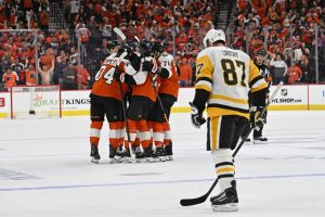 Apr 22, 2026; Philadelphia, Pennsylvania, USA; Philadelphia Flyers right wing Owen Tippett (74) celebrates his empty goal with teammates against Pittsburgh Penguins center Sidney Crosby (87) during the third period in game three of the first round of the 2026 Stanley Cup Playoffs at Xfinity Mobile Arena.