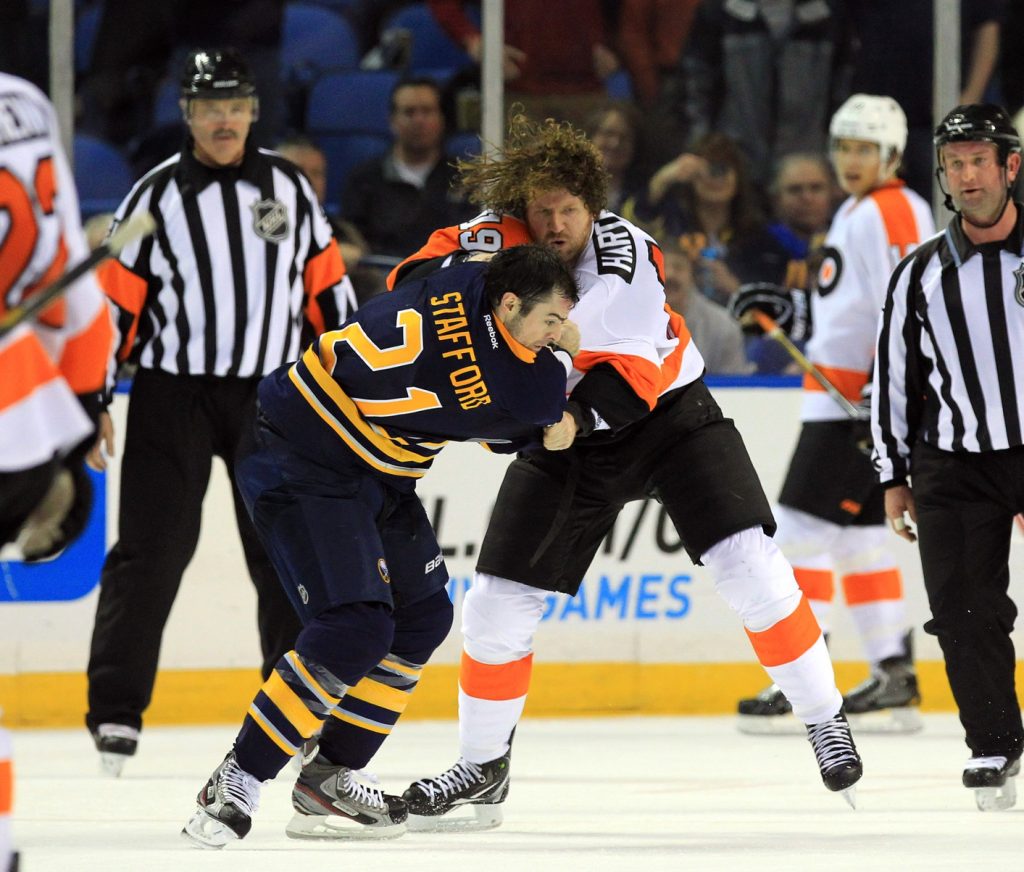 Jan 20, 2013; Buffalo, NY, USA; Philadelphia Flyers right wing Scott Hartnell (19) and Buffalo Sabres right wing Drew Stafford (21) fight during the second period at the First Niagara Center.